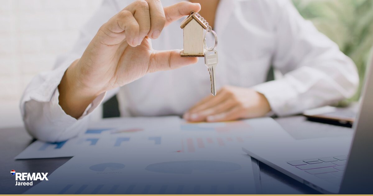 Property valuation documents and calculator on desk with Cairo residential building plans