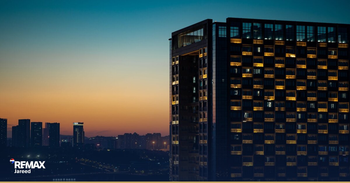 Contemporary residential compound in West Cairo with landscaped grounds and mid-rise apartment buildings under clear sky