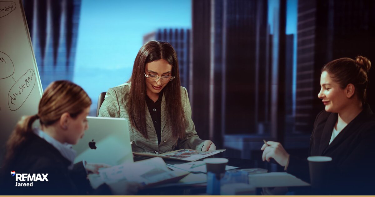 Professional reviewing financial reports and career planning documents at modern office desk