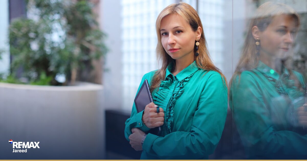 Real estate agent reviewing property listings and client notes in modern office workspace