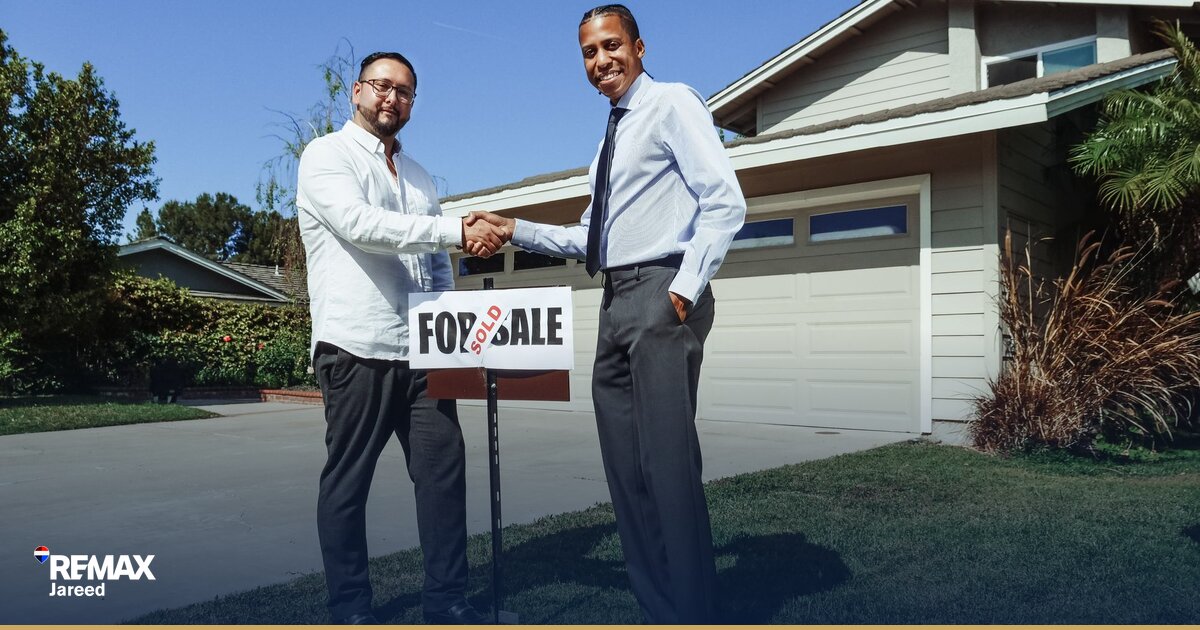 Real estate consultant having focused discussion with client across modern office desk
