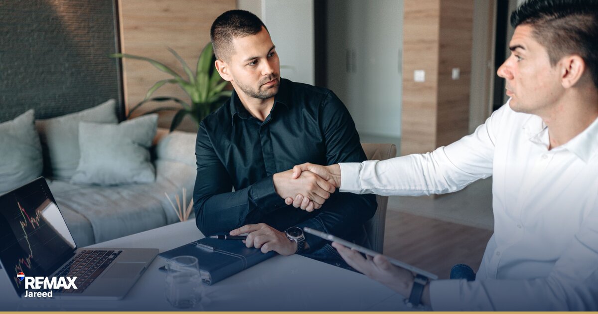 Real estate agent reviewing commission earnings and transaction documents at modern office desk