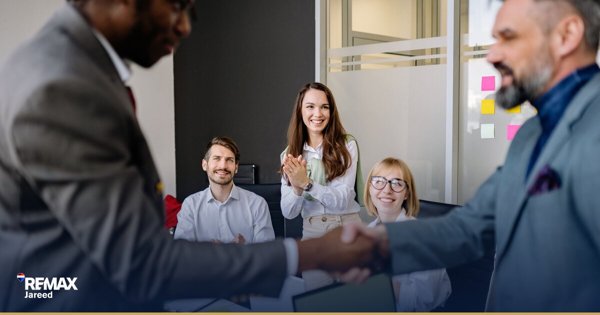 Professional real estate workspace with financial calculator and property documents representing agent commission success