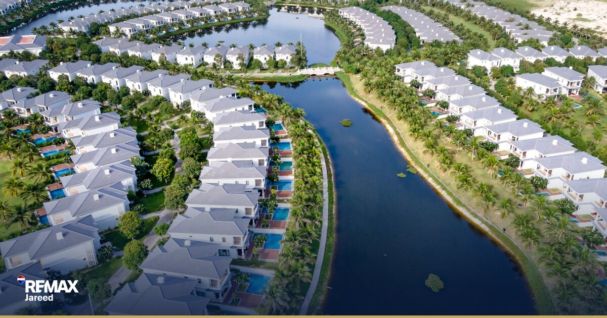 Aerial view of a modern residential compound in Sheikh Zayed City, Egypt, showing landscaped streets and villas