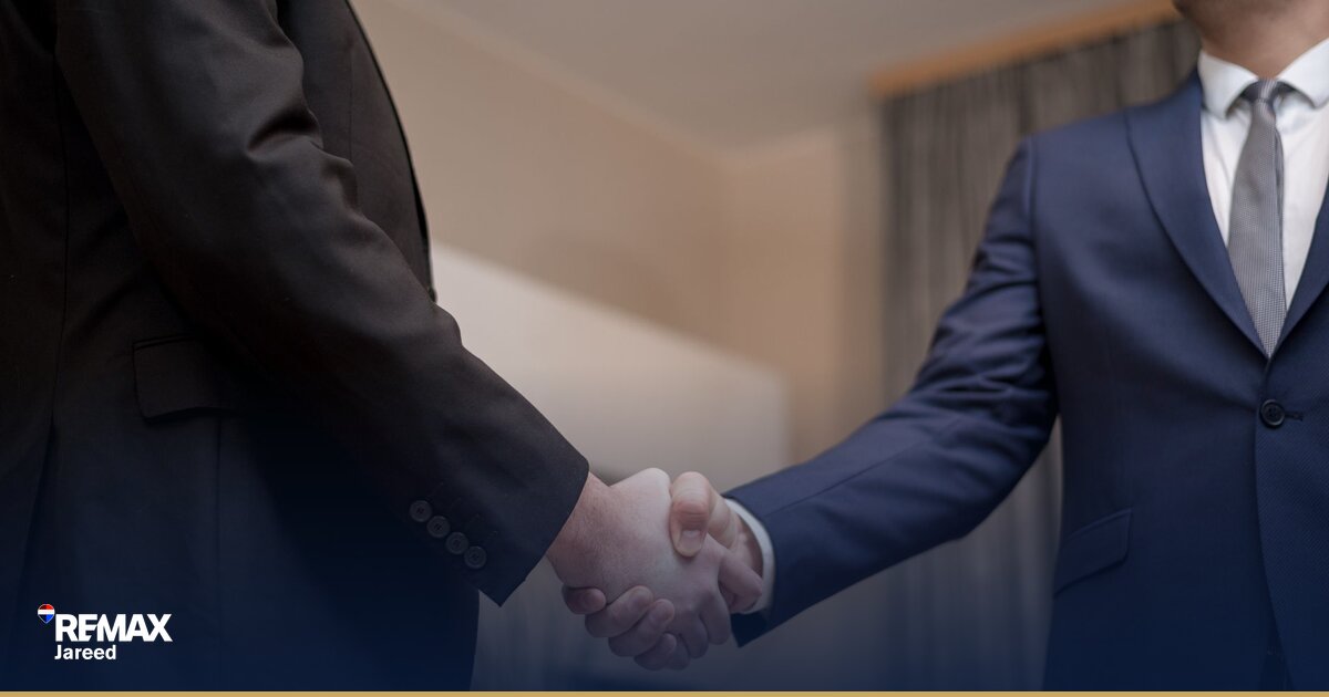 Professional real estate agent closing a property deal in a modern office setting