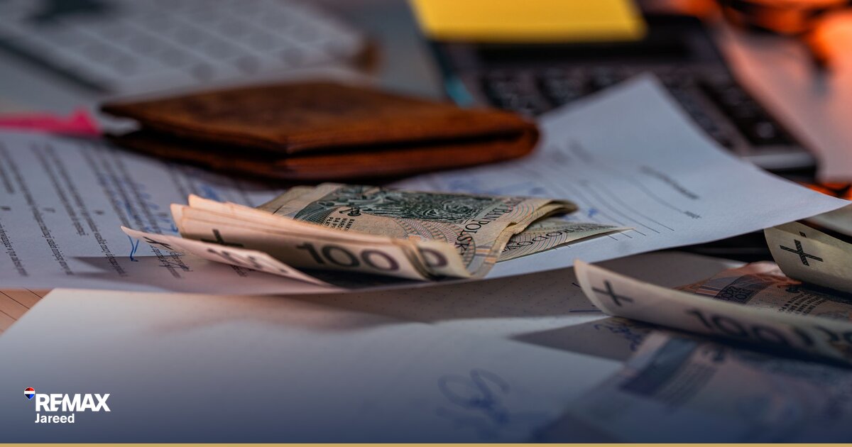 Egyptian homebuyer reviewing mortgage documents with bank loan officer at desk