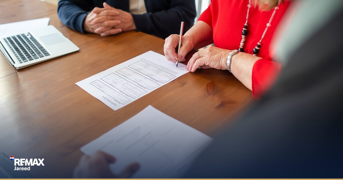 Professional real estate contract signing with documents and keys on modern office desk in Egypt