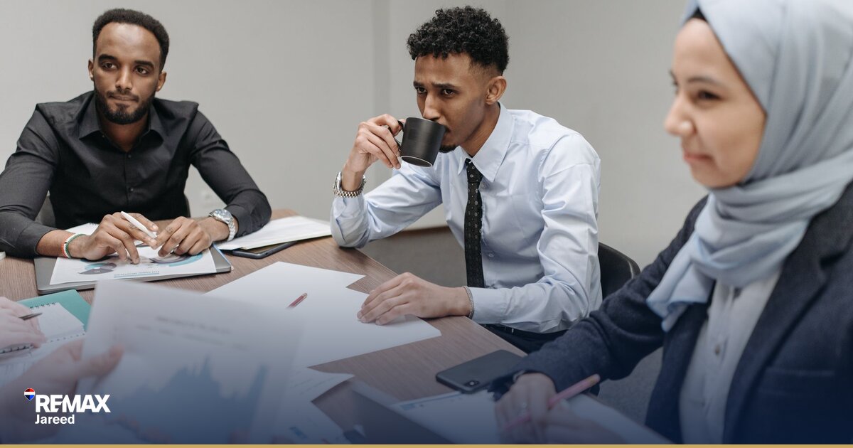 Property consultant and mentor reviewing CRM pipeline on laptop during training session in Cairo real estate office