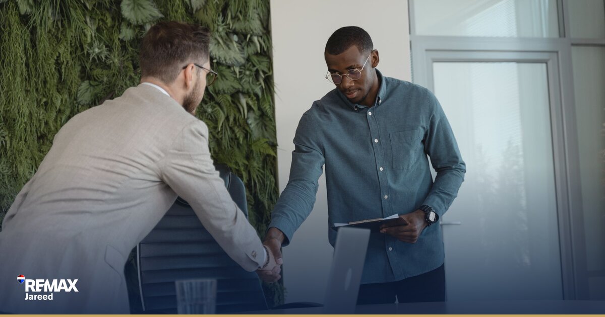 Professional real estate consultant reviewing commission statement in modern brokerage office setting