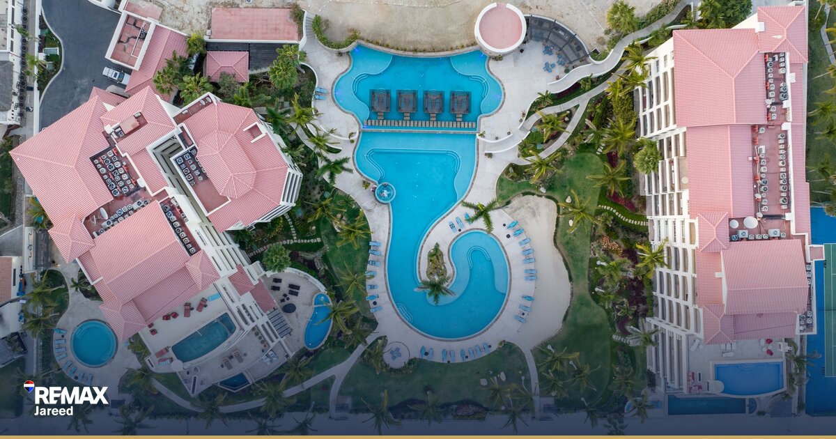 Aerial view of residential compound under construction in Sheikh Zayed with completed buildings and green spaces in West Cairo