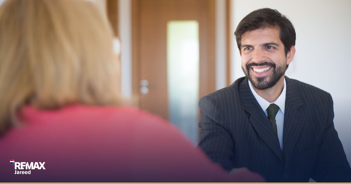 Professional property consultant reviewing documents in modern real estate office in Sheikh Zayed